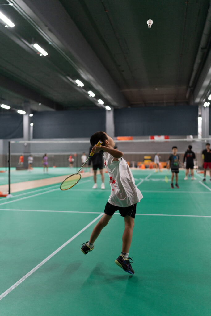 Youth badminton athletes competing at CAN Junior Open tournament, showcasing intense gameplay at CAN Sports Center in Markham